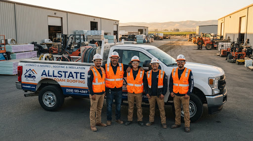 The Allstate Spray Foam Roofing crew in branded high-visibility gear in front of a company truck